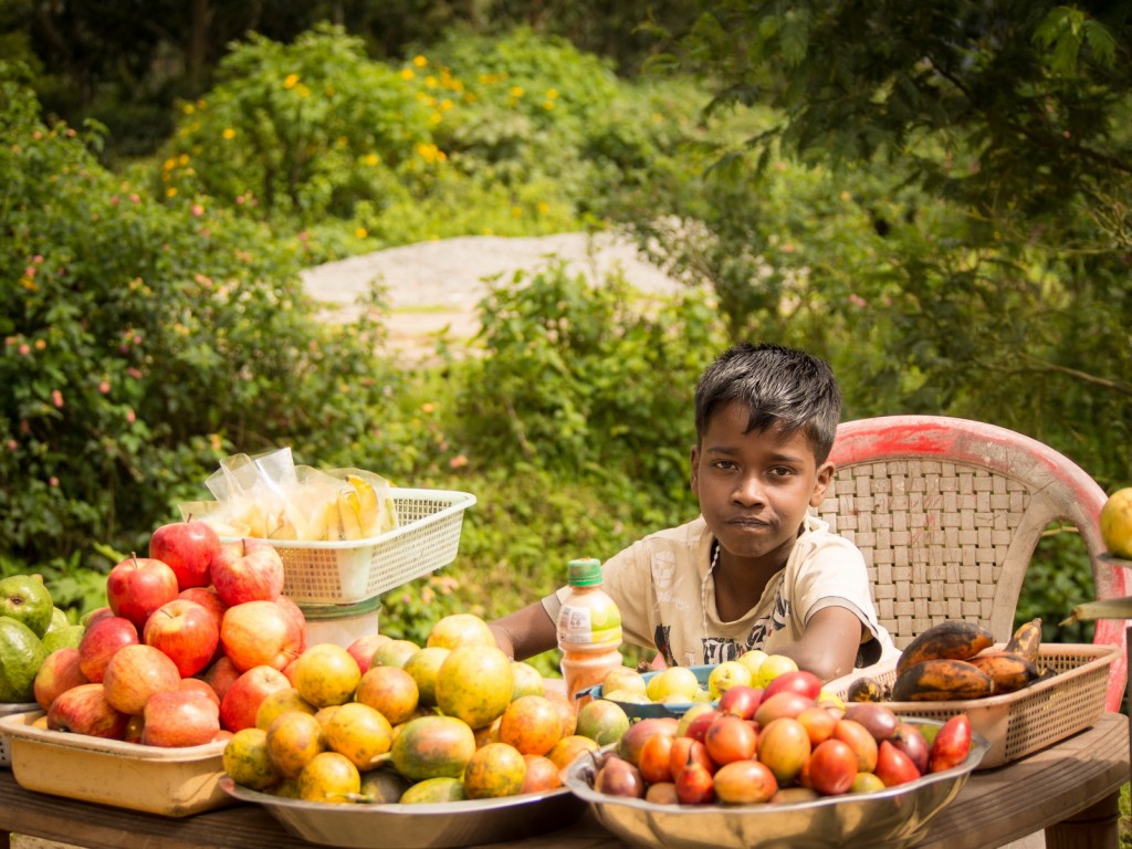 Munnar boy doing homework at the market place
